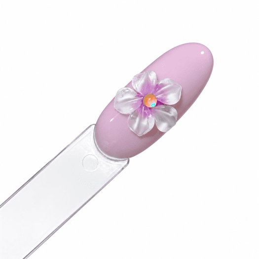 Nail art med Glass Petals Box, blomma av fem kronblad med lila skiftning och sten i mitten på rosa gellack