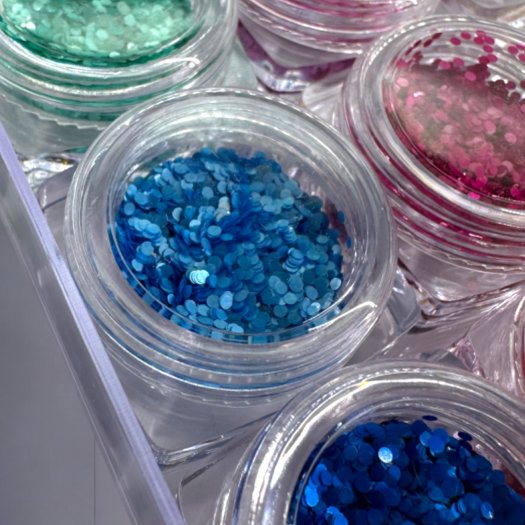 Pärlskimrande paljetter i 1 mm storlek. Set med 12 olika färger för eleganta och kreativa nageldesigner.