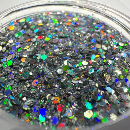 Glit-Mix Holo Silver Storm is a silver glitter with a holographic effect in mixed sizes. 5g jar. Used in sticky gel, capsules