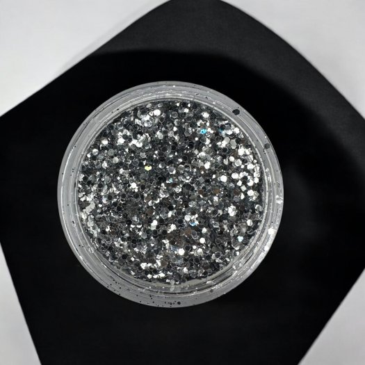 Glit-Mix Pure Silver is a pure silver glitter in mixed sizes. 5g jar. Use in sticky gel, encapsulate or sprinkle over T