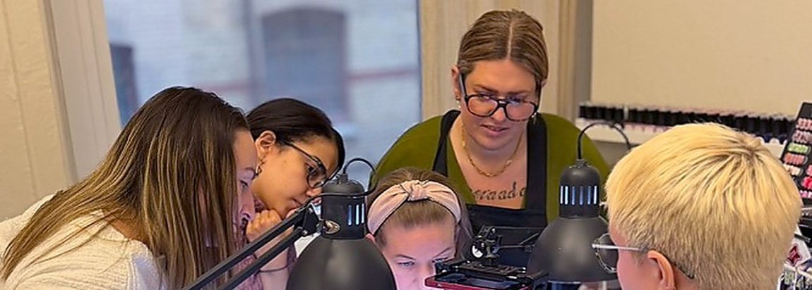 Students and teacher at the nail desks during a Nail Systems course day